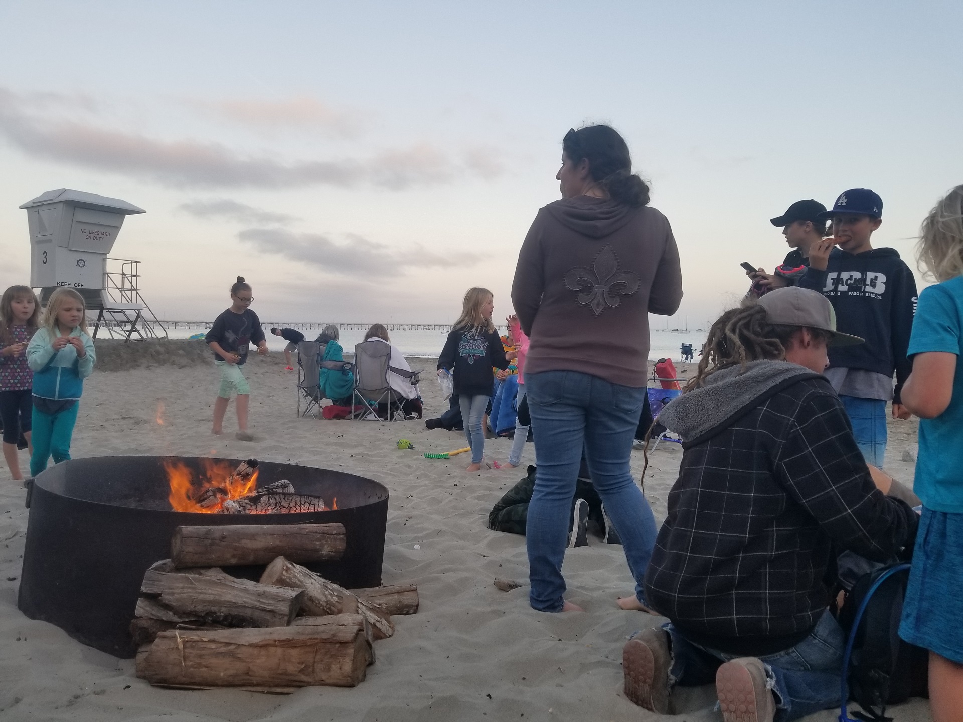 group of people at beach bonfire